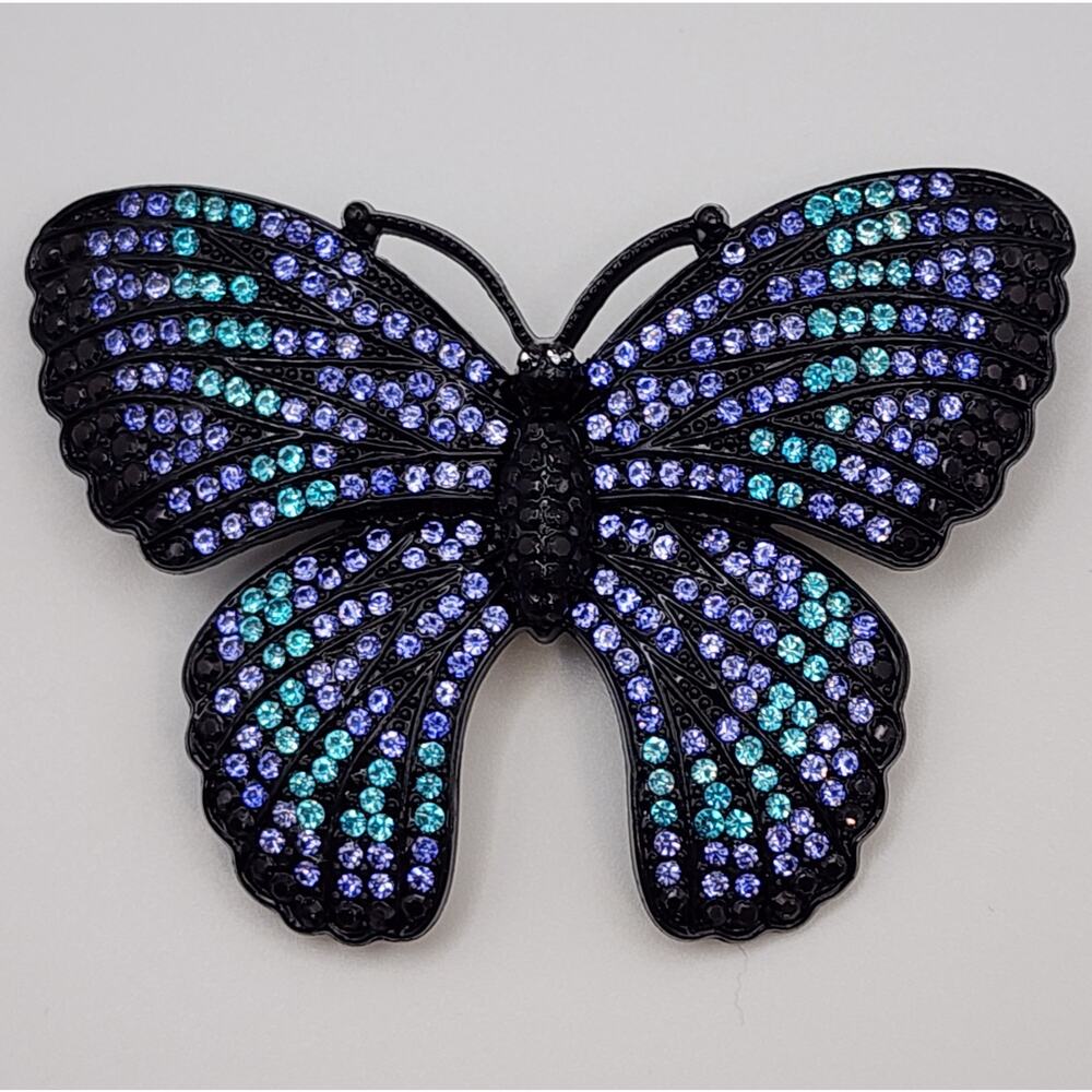Butterfly Rhinestone Brooch Blue and Purple Stones on Black Metal Background